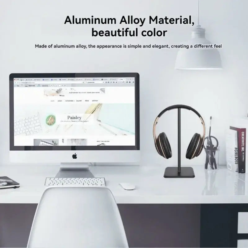 Modern office desk setup with computer, chair, and headphone stand on a white background