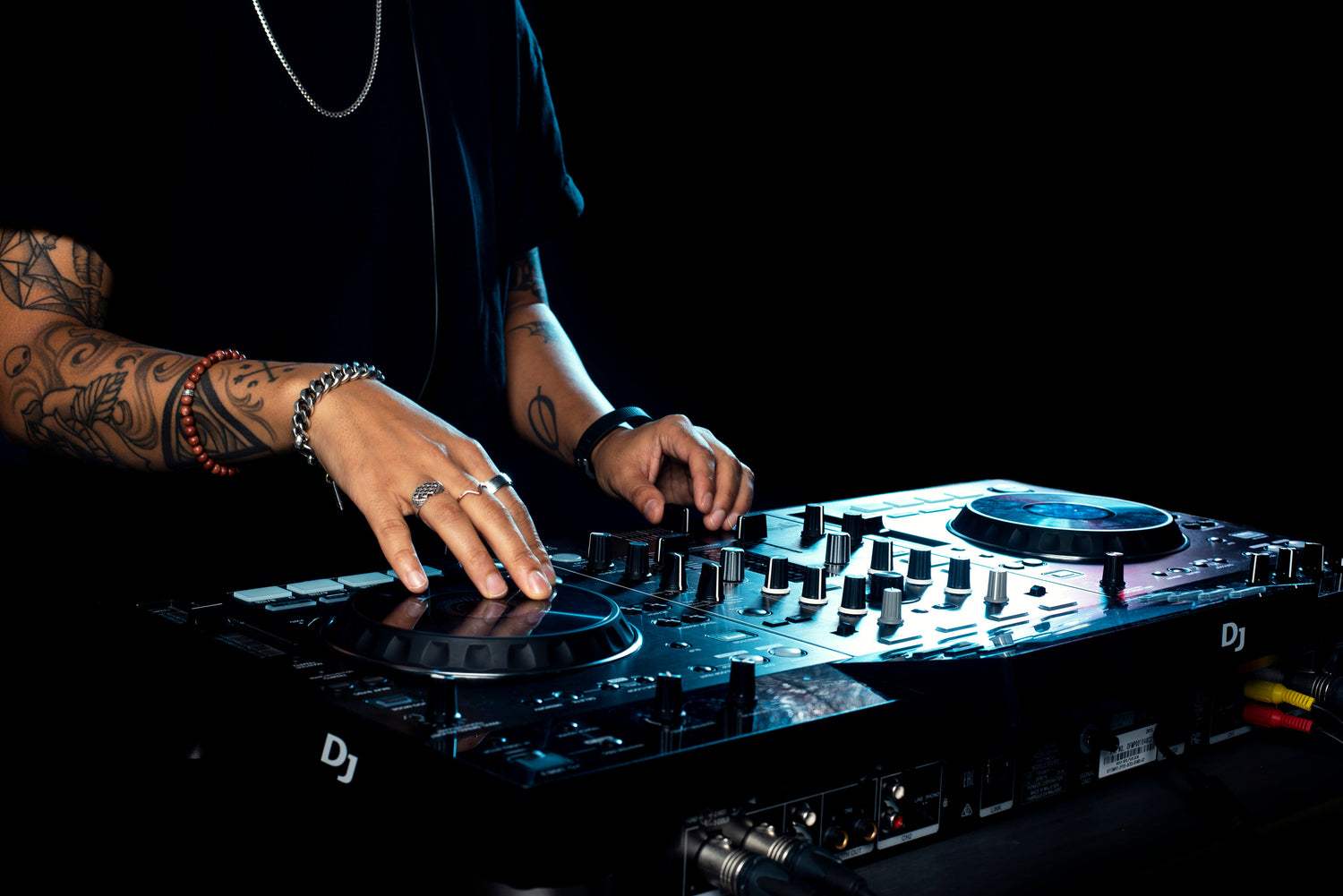 Hands of a DJ using a professional controller, showcasing new arrivals in pro audio equipment.